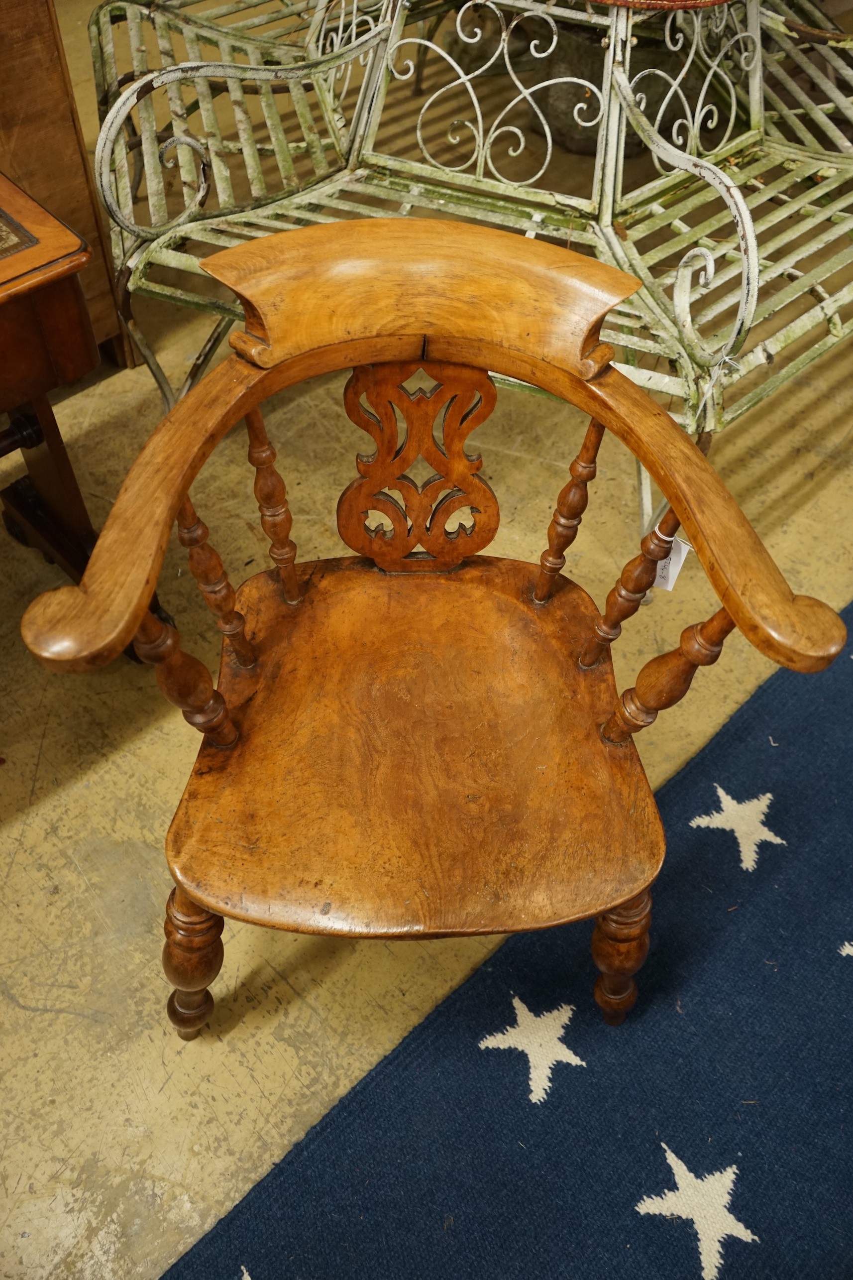 A Victorian elm and beech pierced back bow smoker's chair, width 66cm, depth 45cm, height 80cm